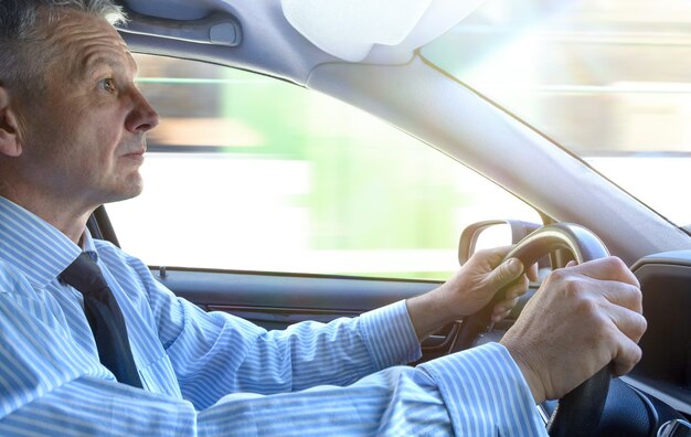 Business man in casual suit driving his car.