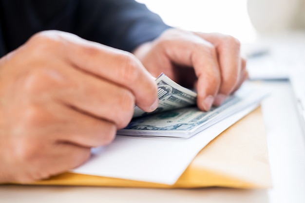 Photo business man counting money at the table, accounting