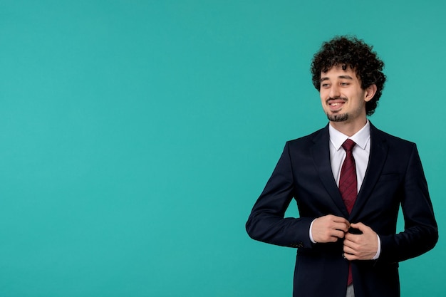 Business man curly cute handsome guy in black suit buttoning jacket