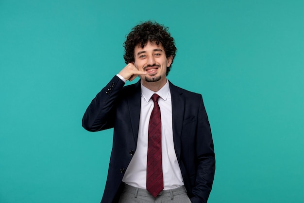 Business man curly cute handsome guy in black suit making phone call gesture