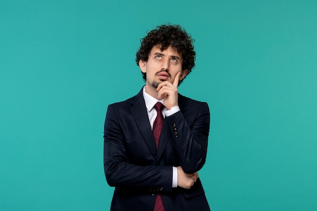 Business man curly cute handsome guy in black suit thinking and looking up