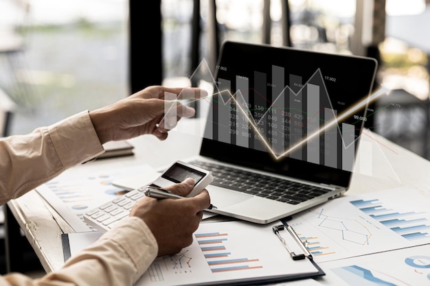 A business man examines data on financial documents company financial reports graphics showing financial and numerical growth data The concept of financial management to grow and be profitable