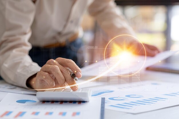 A business man examines data on financial documents company financial reports graphics showing financial and numerical growth data The concept of financial management to grow and be profitable