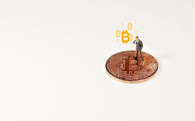 Business man figure standing on bitcoin Bitcoin mining concept