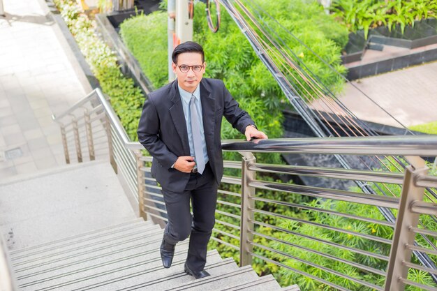 Business man going up the stairs  in a rush hour to work. Hurry time.