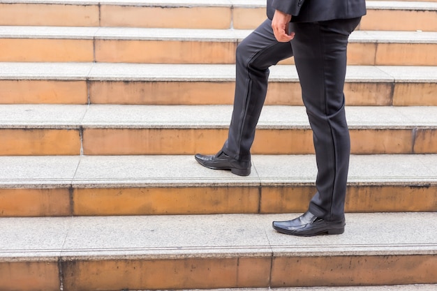 Photo business man going up the stairs  in a rush hour to work