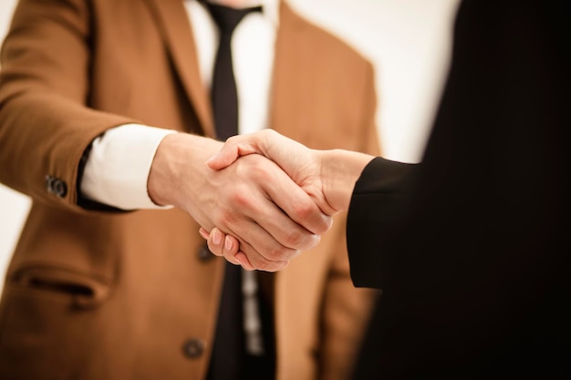 Business man hands shaking Successful businessman handshake after good deal for both companies businessmen handshaking after finishing up meeting