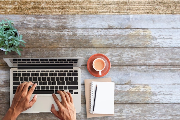 Business man hands using a laptop on workplace