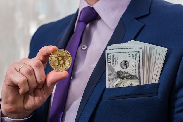 Business man hold dollar and bitcoin in hand