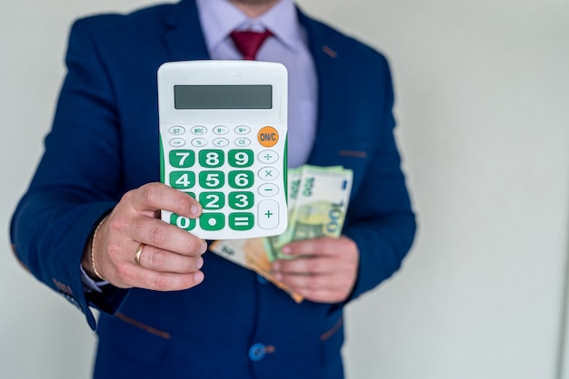 Business man hold euro money and calculator, accounting or exchange concept