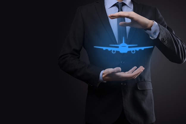 Business man holding holographic airplane.