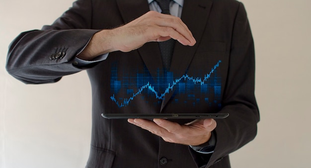 Business man holding holographic graph