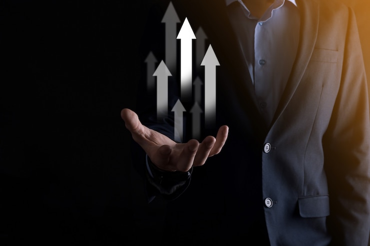 Photo business man holding holographic graphs and stock market statistics gain profits. concept of growth planning and business strategy. display of good economy form digital screen