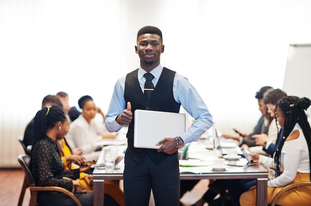 Business man holding laptop at the meeting