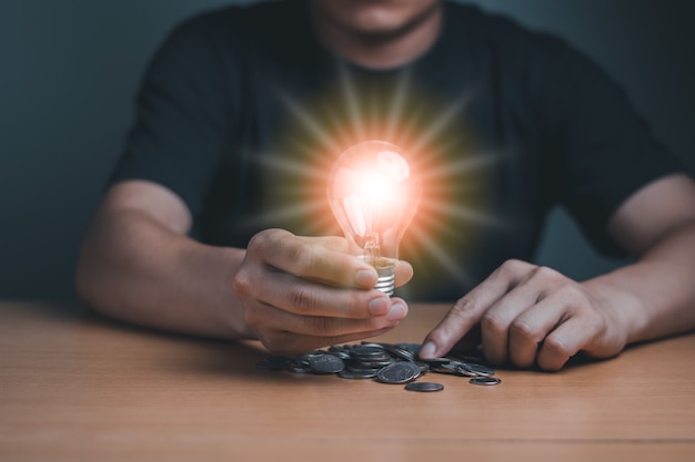 A business man holding the light lamp success of saving and holding concept, computer graphic light idea