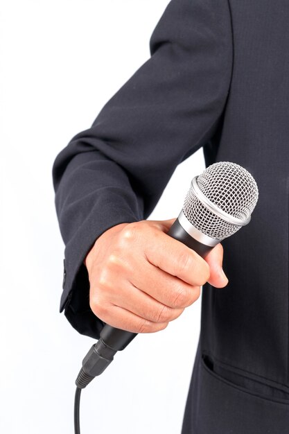 Business man holding a microphone isolated on white background