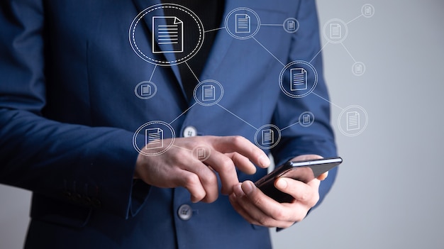 Business man holding phone with document icon