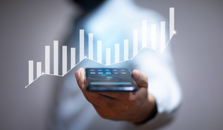 Business man holding smart phone with graph