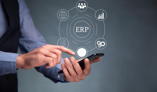 Business man holding smartphone with ERP icon