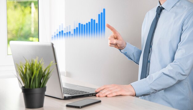 Business man holding tablet and showing holographic graphs and stock market statistics gain profits. Concept of growth planning and business strategy. Display of good economy form digital screen.