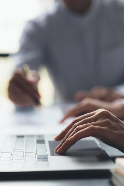 A business man is checking company financial documents and\
using a laptop to talk to the chief financial officer through a\
messaging program concept of company financial management