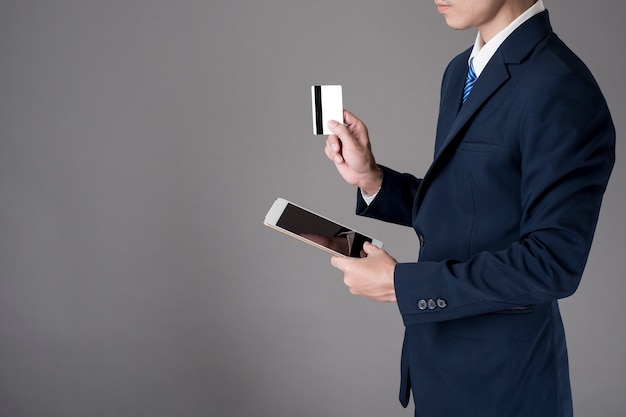 Business man is holding  credit card and tablet, Shopping online concept 