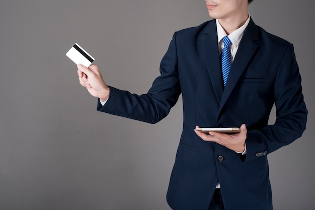 Business man is holding  credit card and tablet, Shopping online concept 