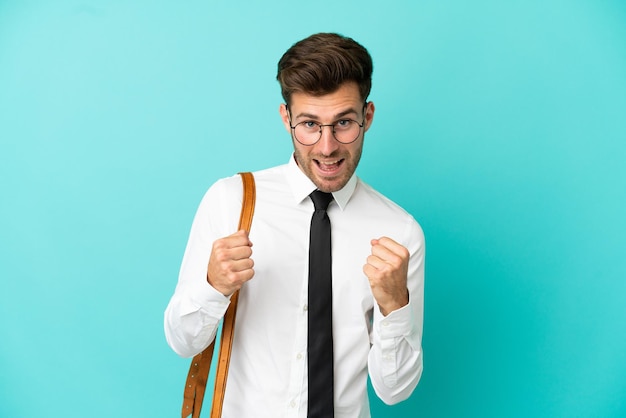 Business man over isolated background celebrating a victory in winner position