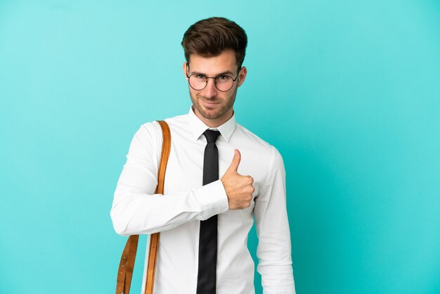 Business man over isolated background giving a thumbs up gesture