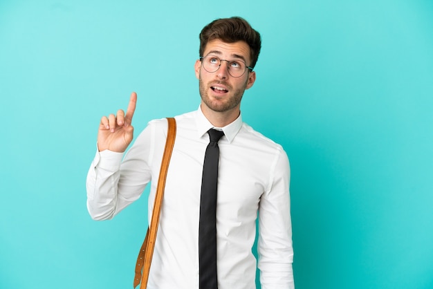 Business man over isolated background pointing up and surprised