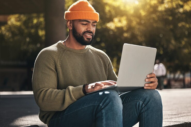 Photo business man laptop and park for outdoor research job search and freelance planning on social media african person with remote work startup career and computer for website marketing and email