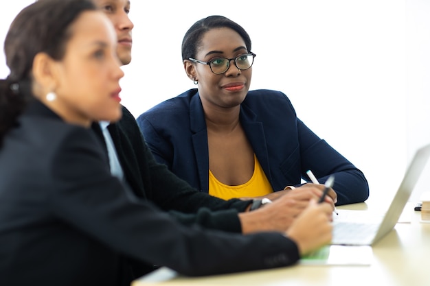 Business man manager leader in meeting with two woman analyzing ducuments on laptop computer in home office.