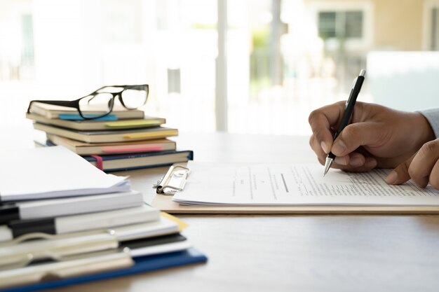 Photo business  man office employee working contract with documents stacks of files paper and law