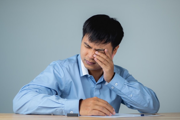 Business man pains his eyes He touches his eye by hands Ophthalmology concept This shot is medium close up portrait