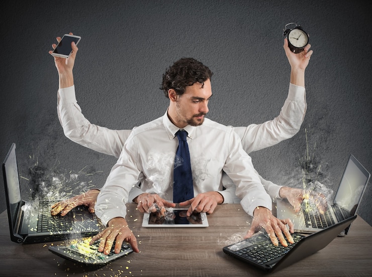 Business man performing multiple tasks at the same time