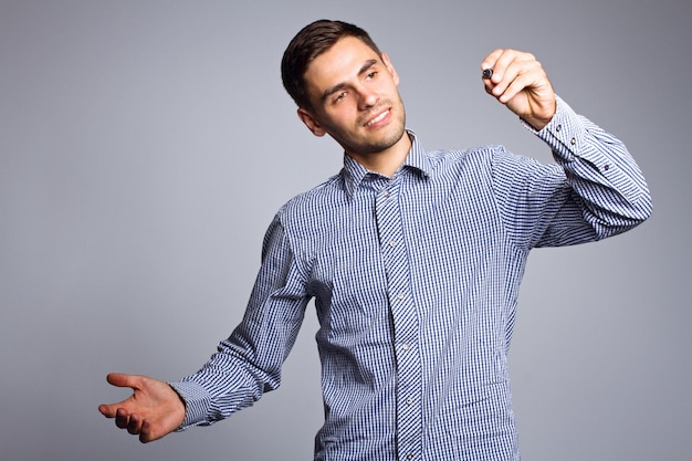 Business man pointing something with marker on gray background