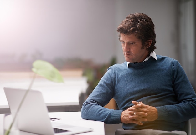 business man reading and thinking on laptop for information technology or programming solution developer or programmer with office computer for cloud computing software or problem solving at night
