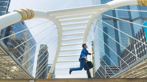 Business man run with laptop briefcase at pedestrian