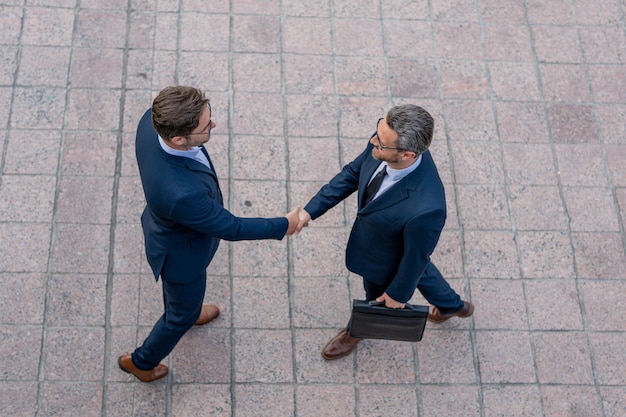 Photo business man shaking hands two businessmen handshake outdoor handshake business people handshake of