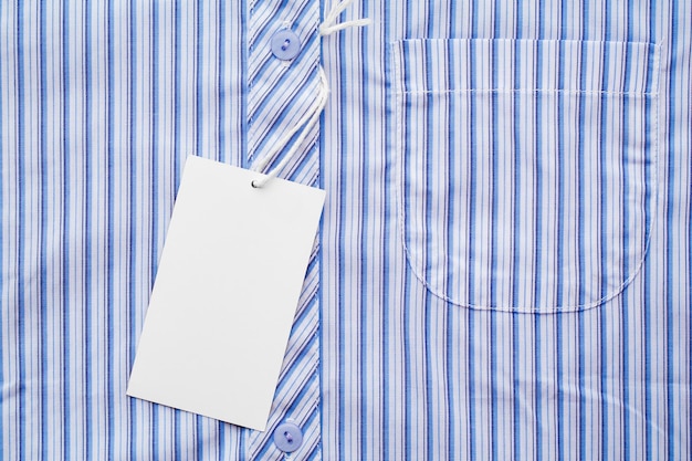 Business man shirt form or formal blue shirt in a checked blue pattern with blank white label or tag attached