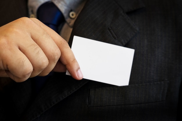 business man showing business card. Black suit and tie.