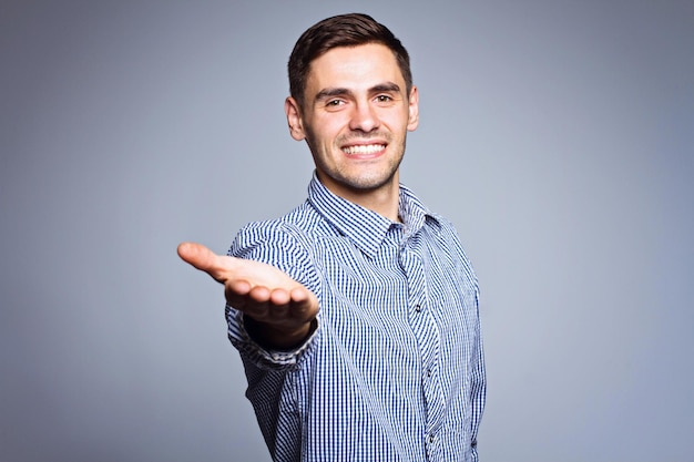 Business man showing something on gray background