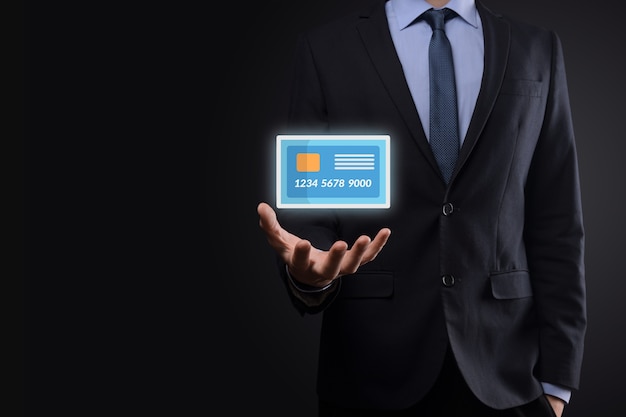 Business man in suit hand holding blank credit card icon showing for concept banking and finance service.