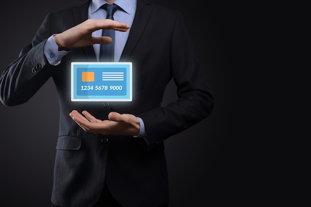 Business man in suit hand holding blank credit card icon showing for concept banking and finance service.