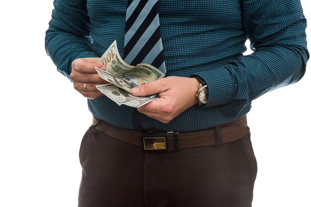 Business man in suit holding us dollar bills, isolated on white.