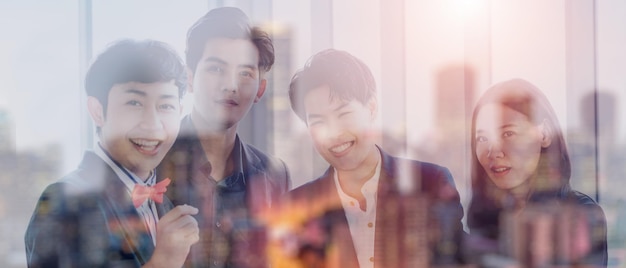 Business man in a suit shakes hands to agree a business partnership agreement Business etiquette concept of congratulation concept of handshake during office meeting double exposure of business