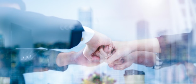 Business man in a suit shakes hands to agree a business partnership agreement Business etiquette concept of congratulation concept of handshake during office meeting