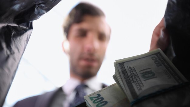 business man takes out money from a plastic bag