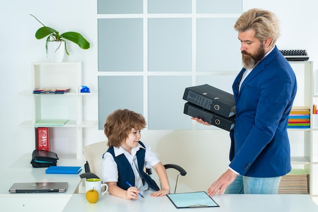 Business man talking with young worker in office Business people at office and consulting Managing employee on report Kid in office Old and yong business concept