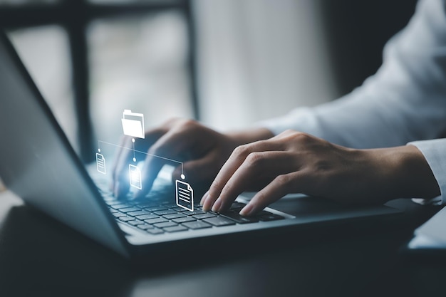 business man typing on a keyboard with holograms of digital document files data files on computers stored as cloud databases can be viewed online and prevented data loss from the device